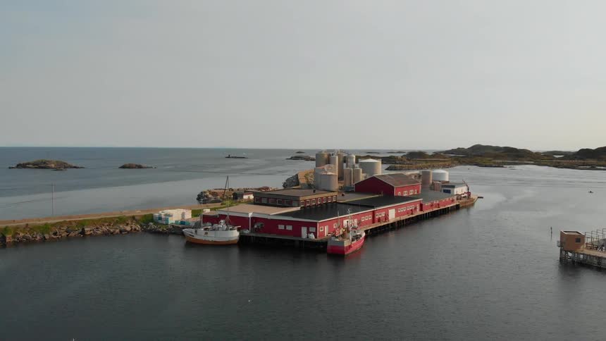 Boats are floating docked at warehouse in a remote port during the day