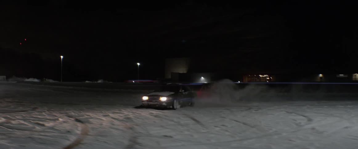 A car spins cookies in a snowy parking lot
