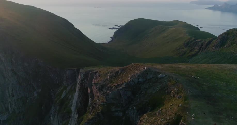 The cliffs are covered with green at the top