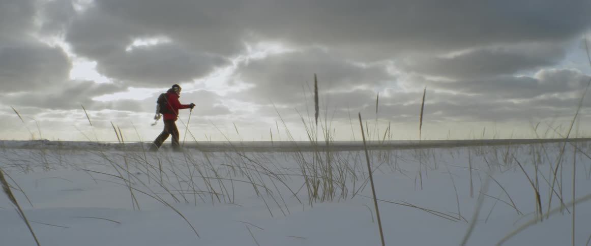 A man climbs a snowy hill