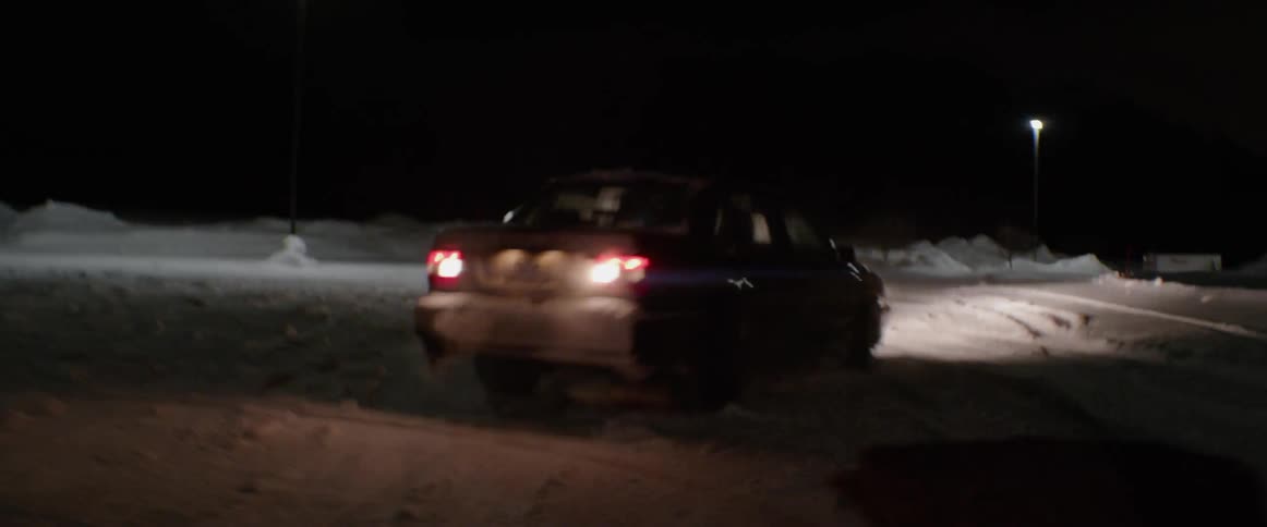Car skids on the snow in the dark