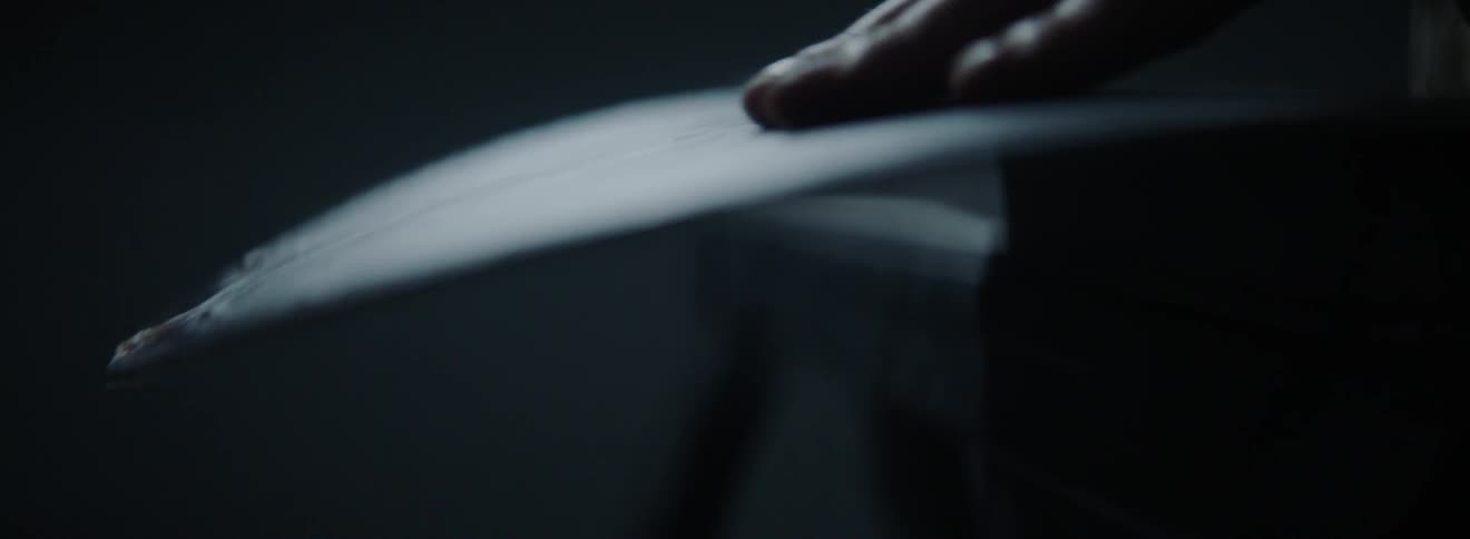 A man touches a curved board