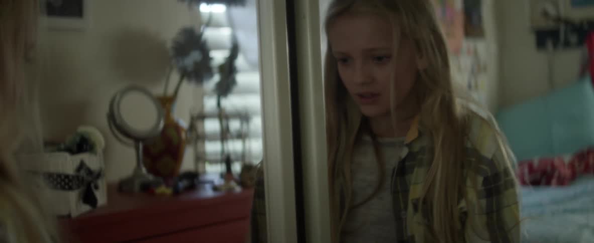 Child screaming at herself in the mirror