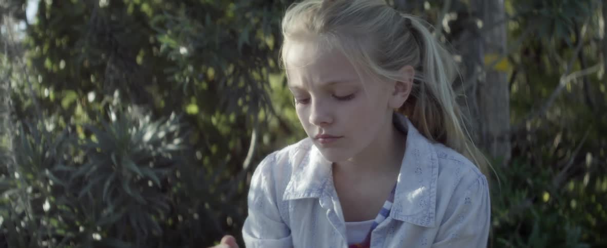 Girl picks up glass and examines it