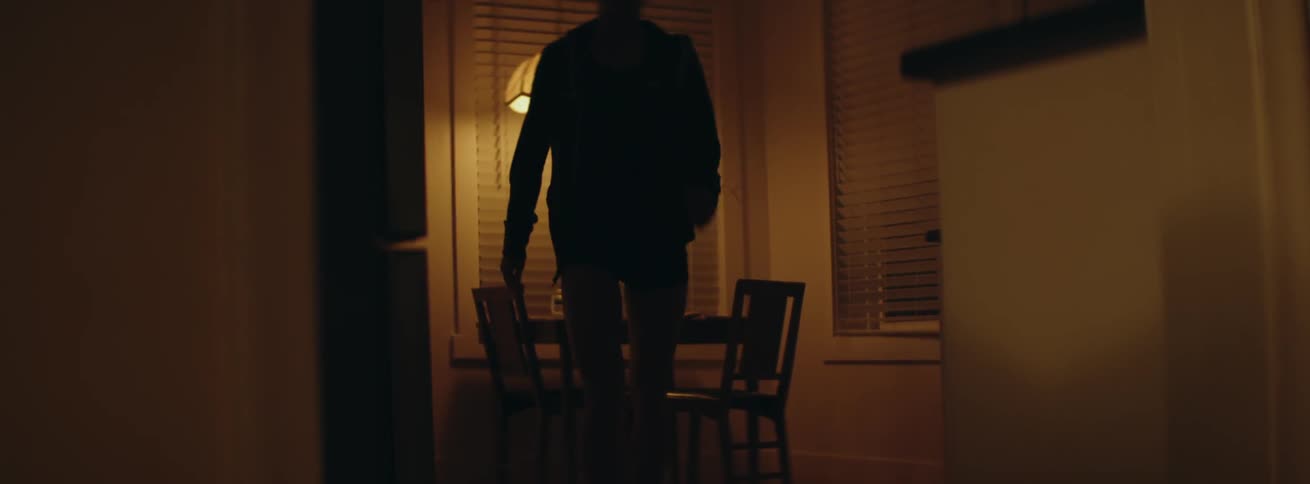 Woman stands up and walks away from a dining table