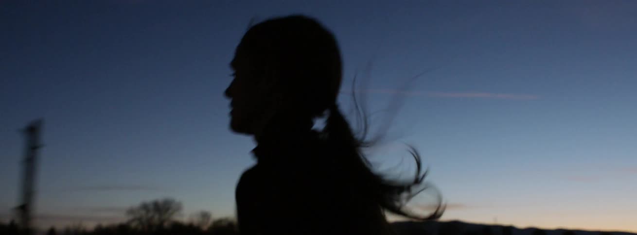 A woman is running at sunset