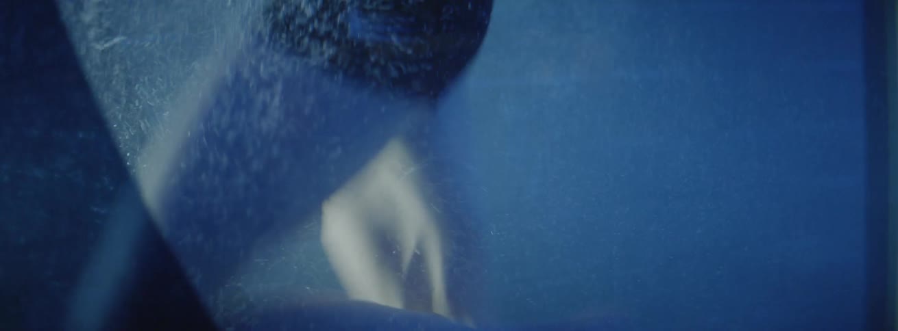 A female athlete is jogging inside a chamber filled with water