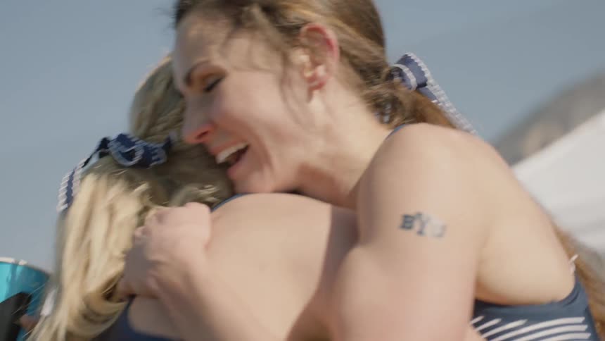 Female runners hug and congratulate each other after a race