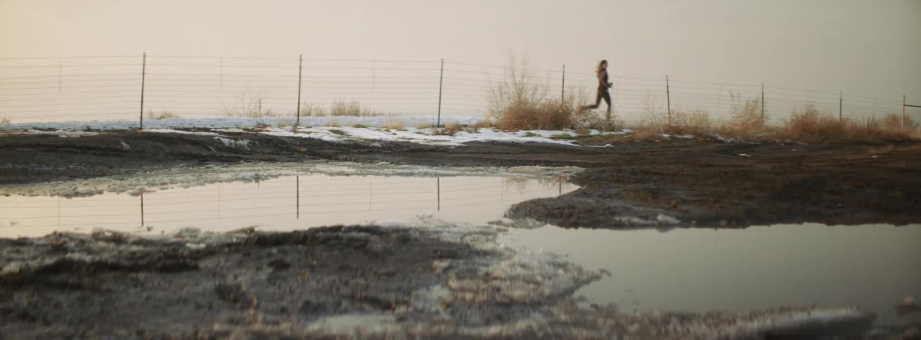 Woman jogs on a rural road