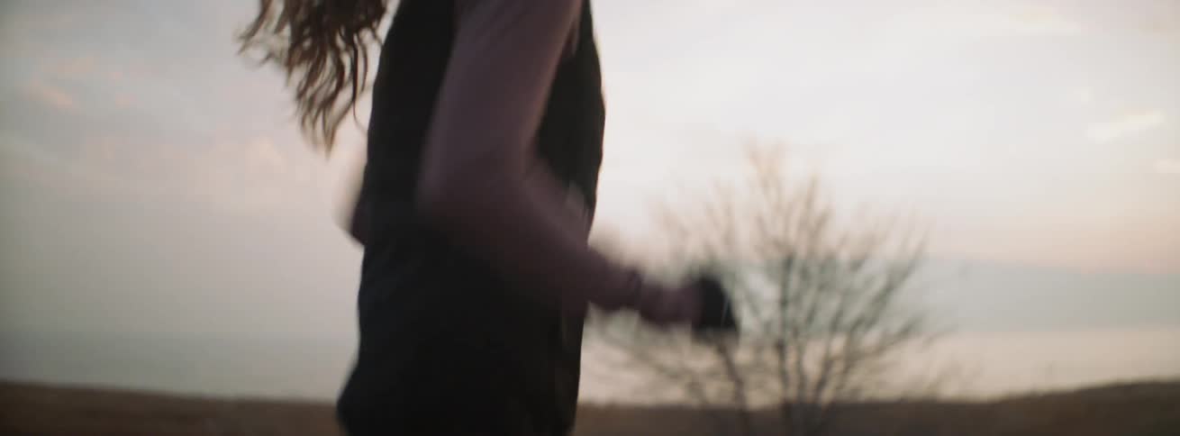 A woman jogs on the trail on a cloudy day