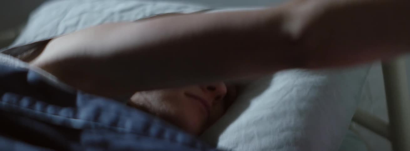 A woman is woken up by a light