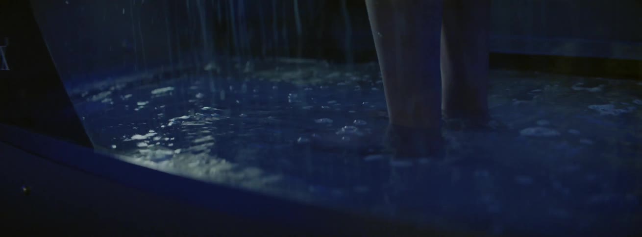 Person stands in a shallow pool of water