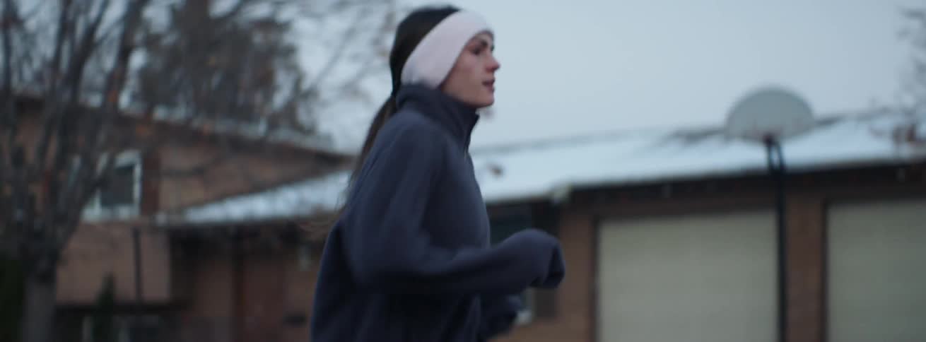 A woman jogs down the street