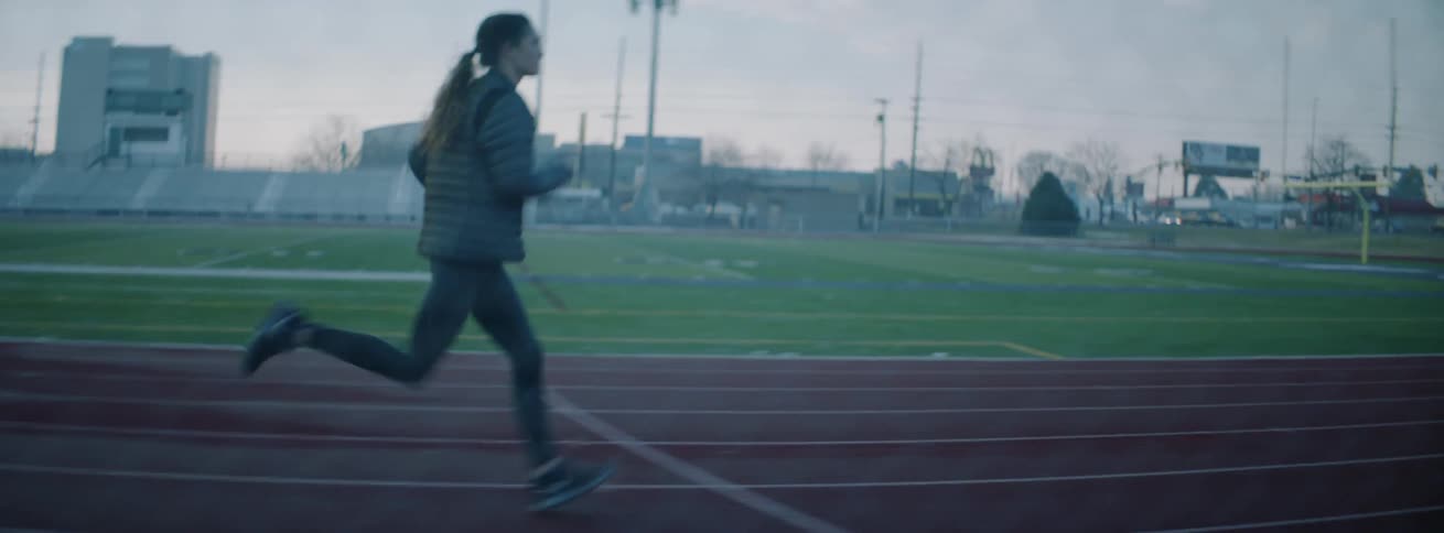The woman races on the track on a foggy day