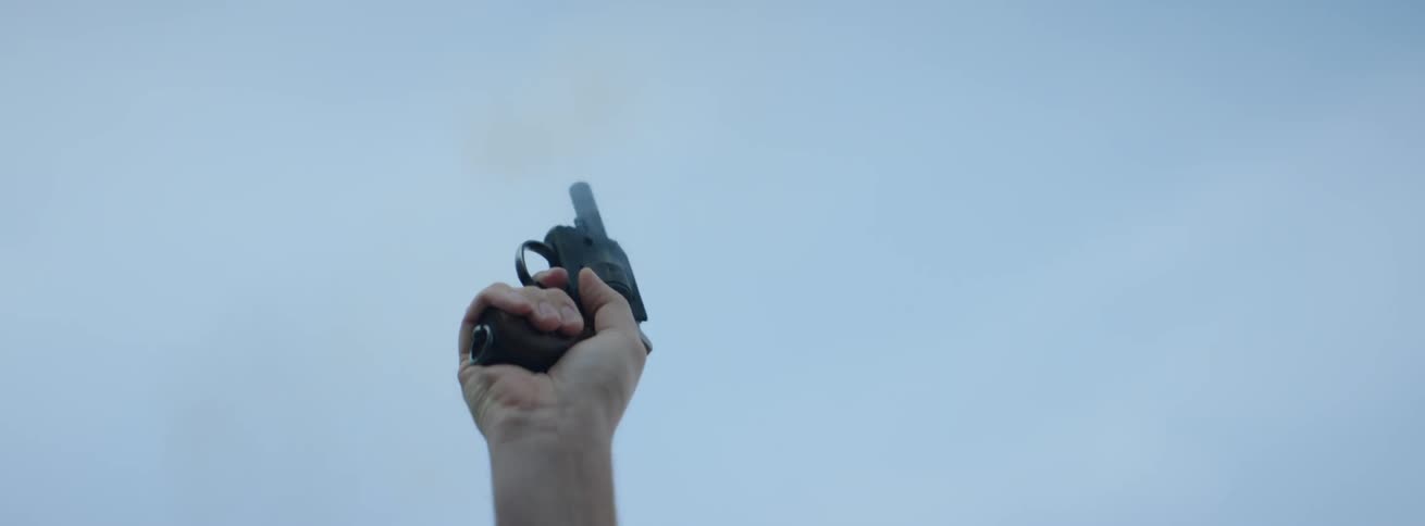 A pistol is fired into the air