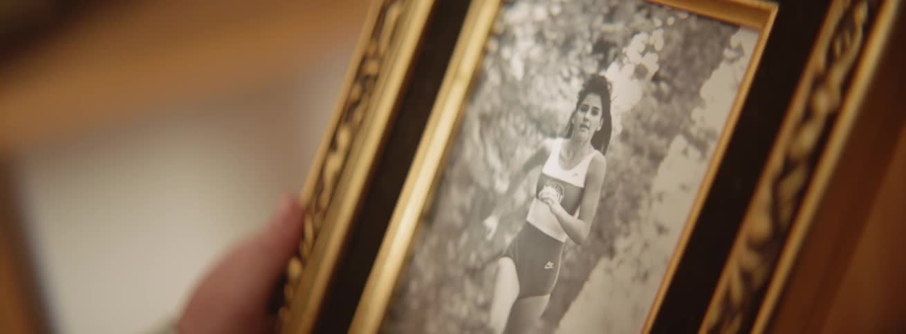 The photograph shows a woman running