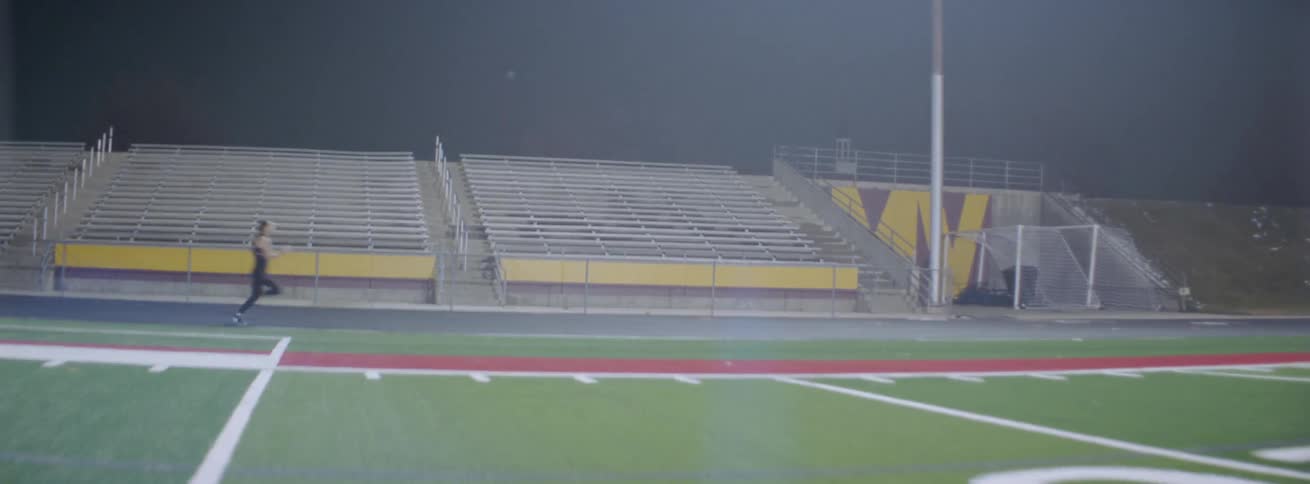 Woman runs on an outdoor track