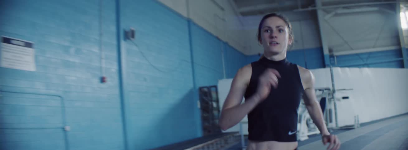 Woman runs on an indoor track