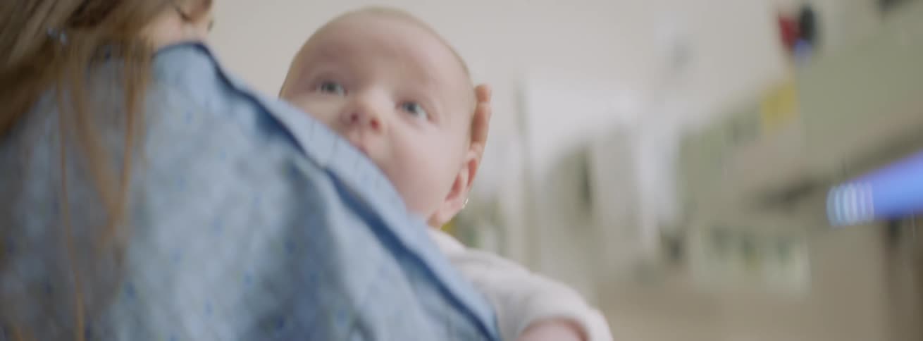 A woman holds an infant