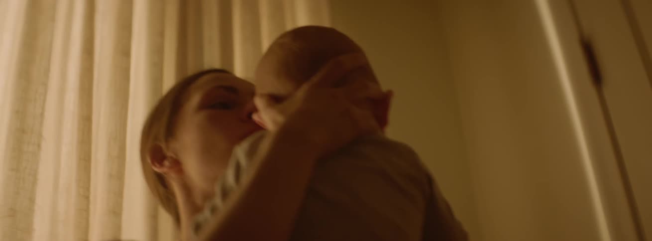 The woman rocks her baby fast in the bedroom