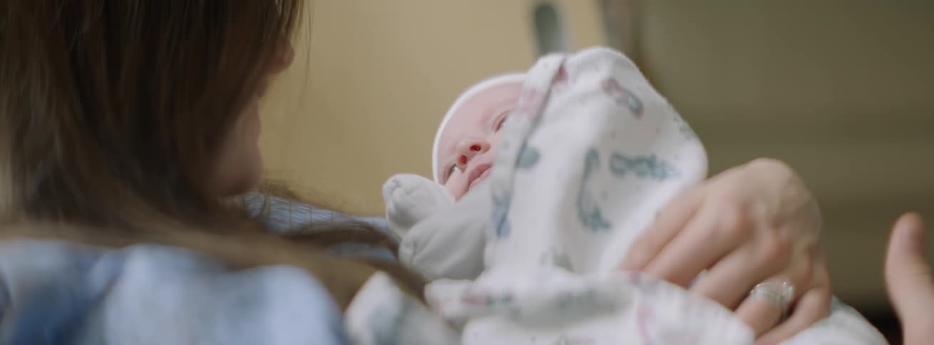 The baby moves around in the mother's arms