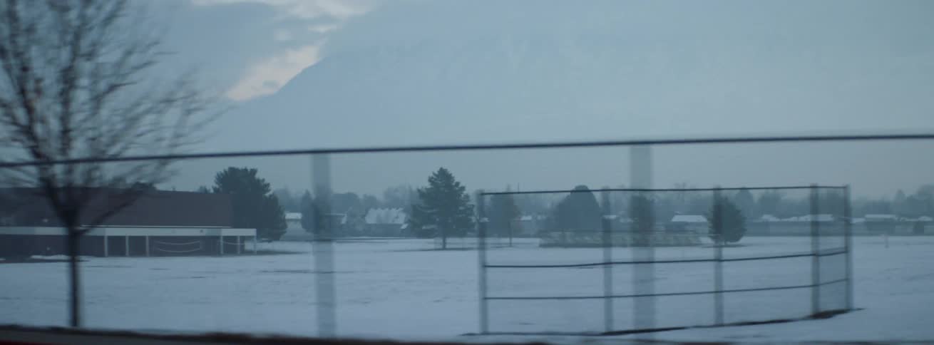 Snow covers the grounds outside of a school