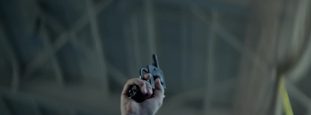 A hand fires a starter pistol inside a building