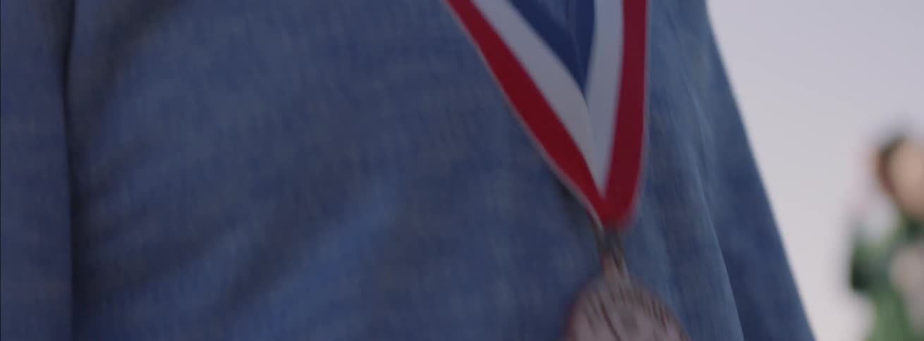A woman is giving a medal