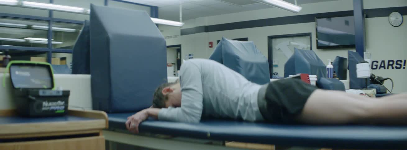 A woman is resting on the table, and getting a massage