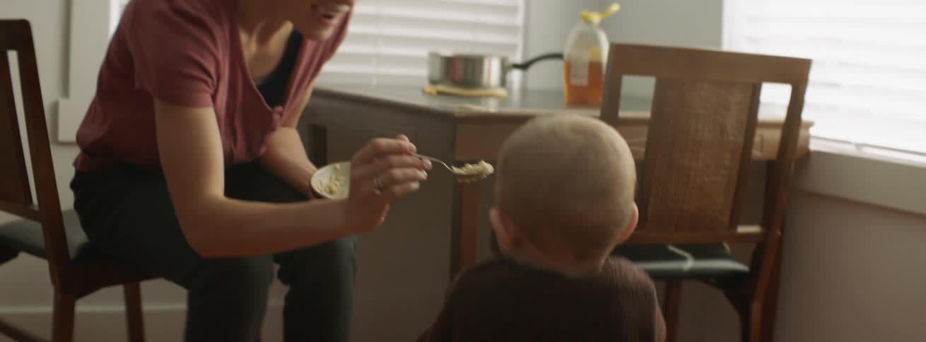 The baby walks over to be fed some food