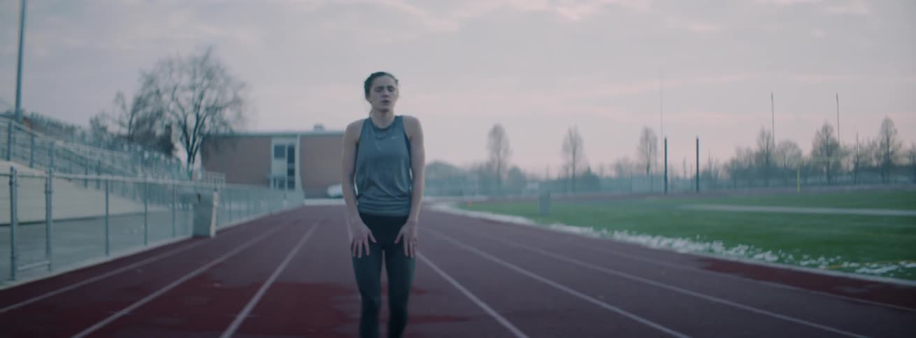 A runner stops to catch her breath on an outdoor track