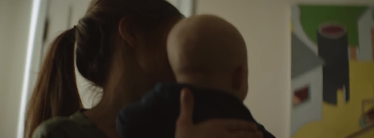 Woman pats a baby's back