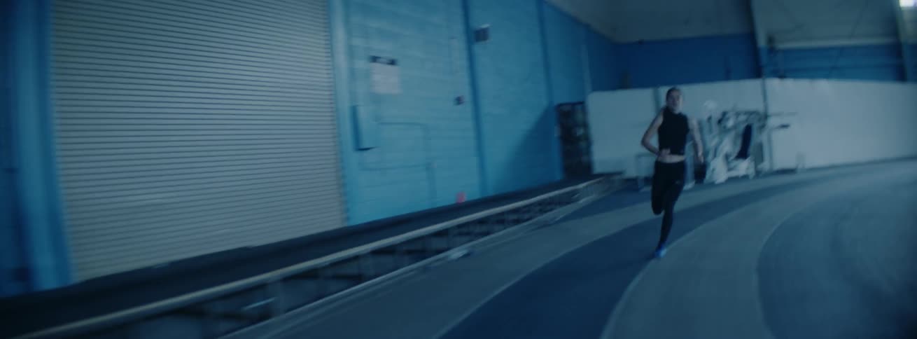 Woman runs on an indoor track
