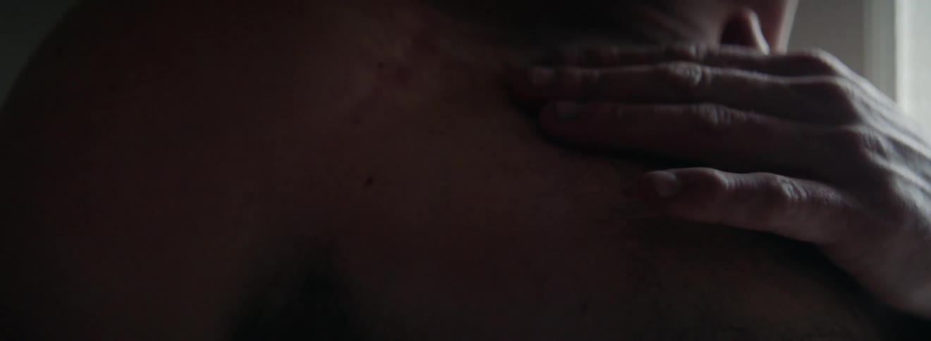 A man rubs his shoulder