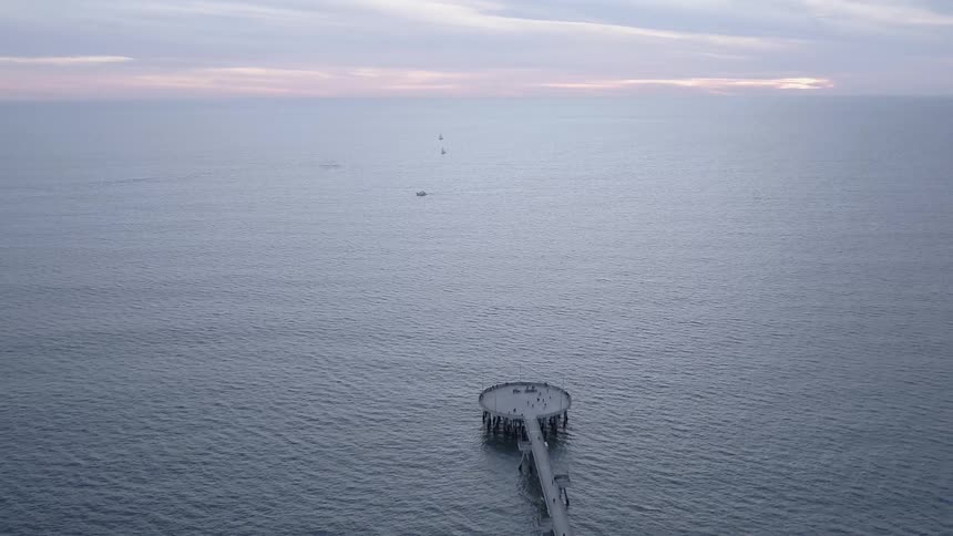 The pier leads out into the vast ocean