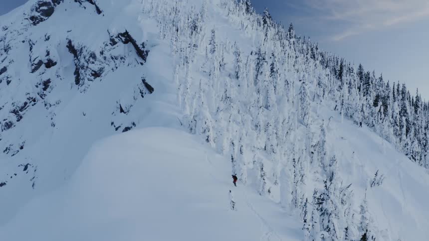 A man hikes up a snowy mountain