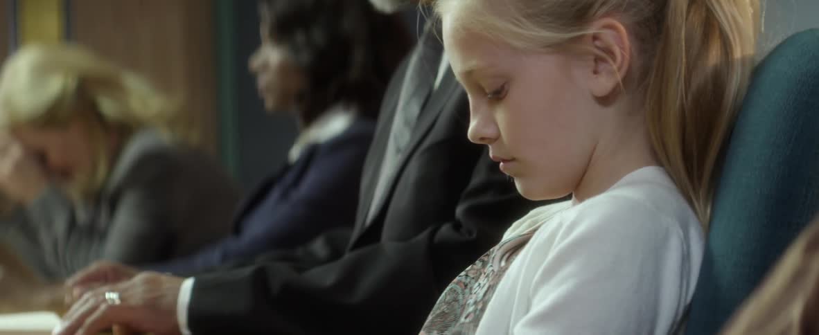 A woman and child look upset as they sit with a couple in between them