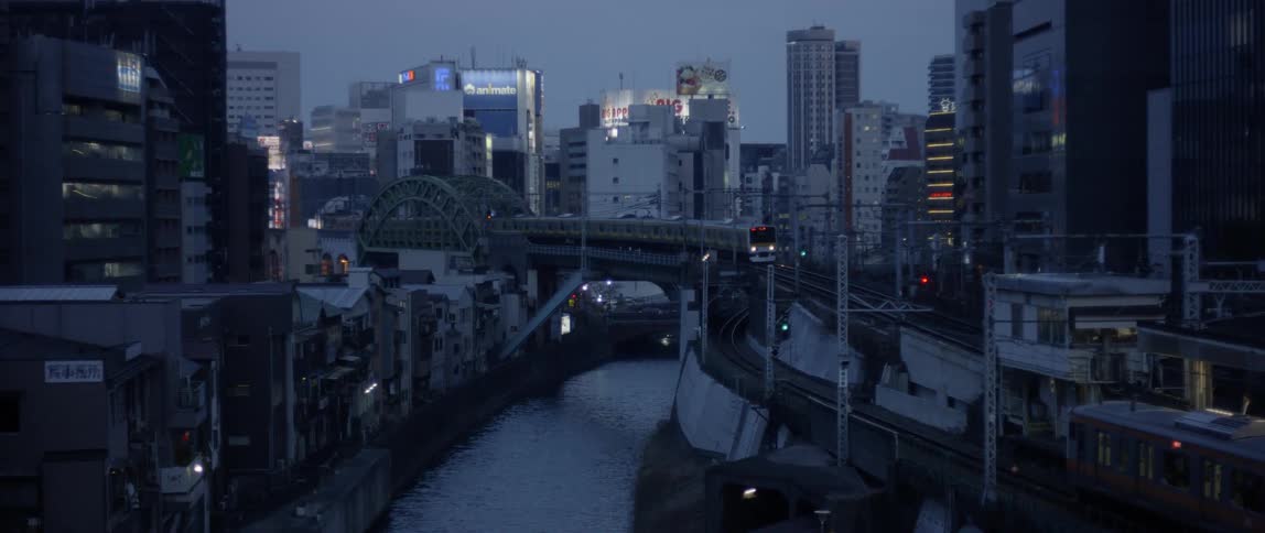 A commuter train travels on a city bridge