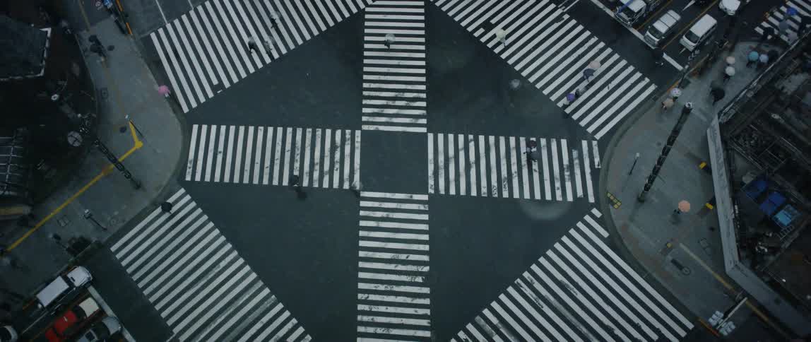 People cross the intersection below in the city