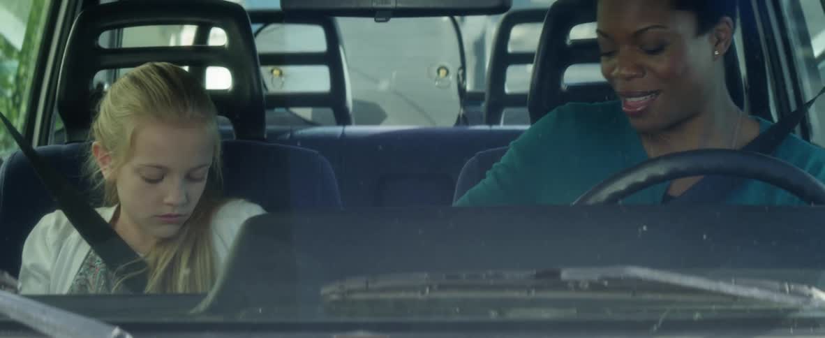 Girl and woman sit and talk in a vehicle