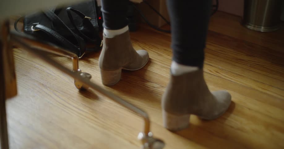 Woman taps her foot while wearing boots