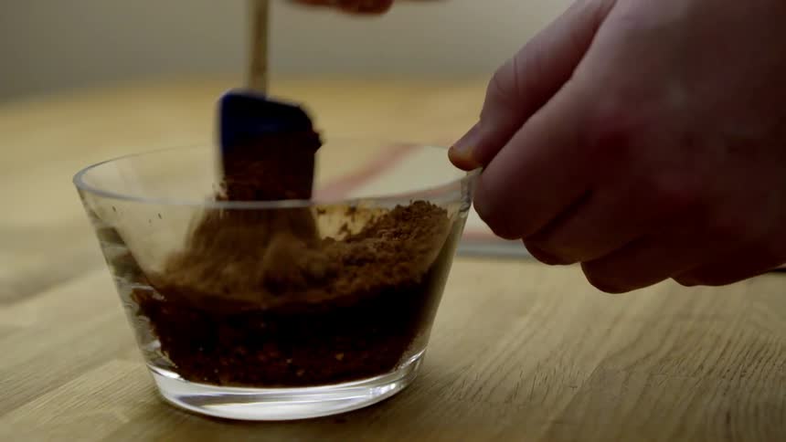 An ingredient is poured into a bowl and stirred