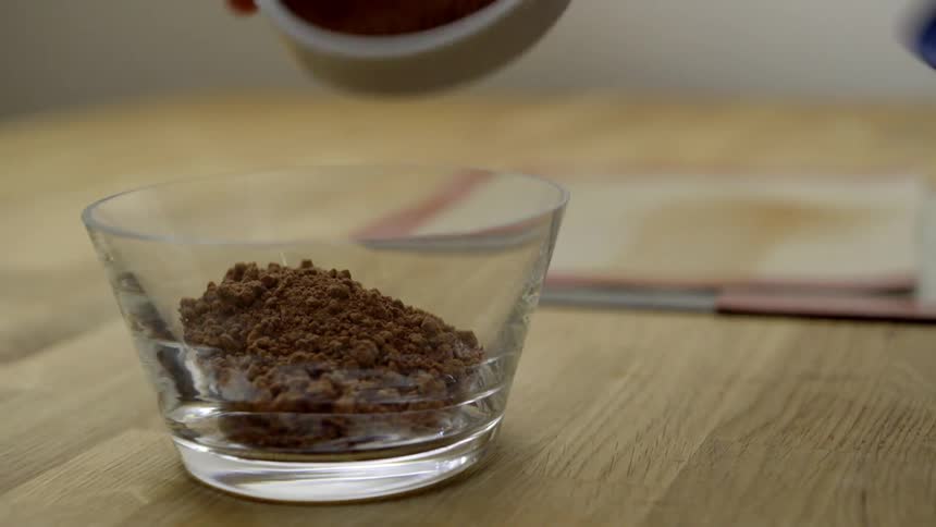 Spices being poured into a small glass