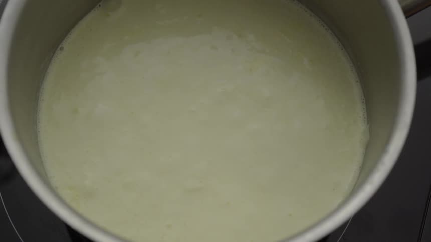 Liquid slowly bubbles in a pot