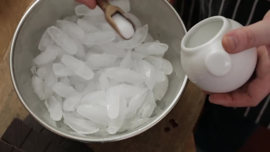 Salt is poured over a bowl of ice