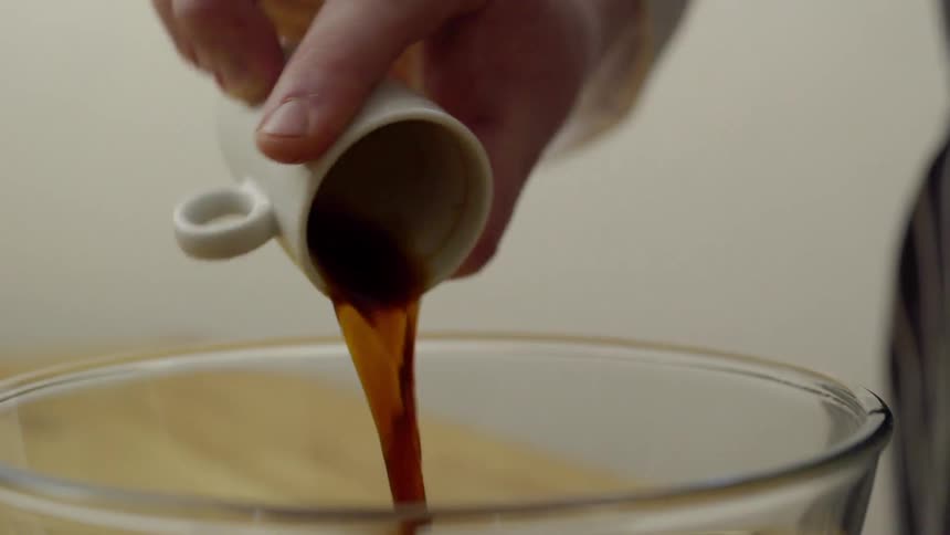 An ingredient is poured into a bowl