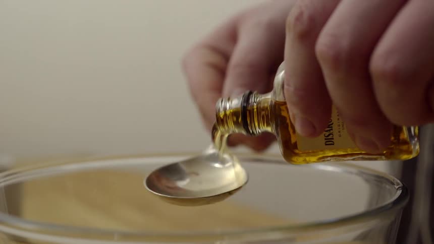 A liquid is measured and poured into a mixing bowl