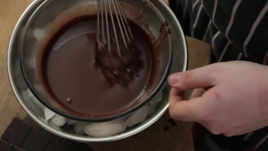 Woman setting a bowl of chocolate into ice