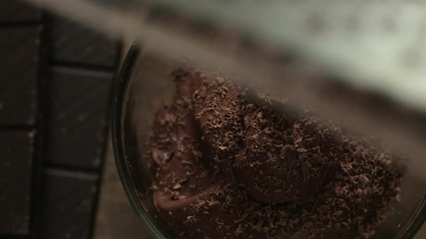 Chocolate is grated on top of a bowl of food
