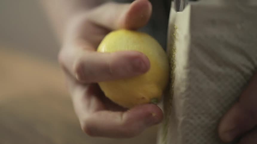 A person zesting a lemon